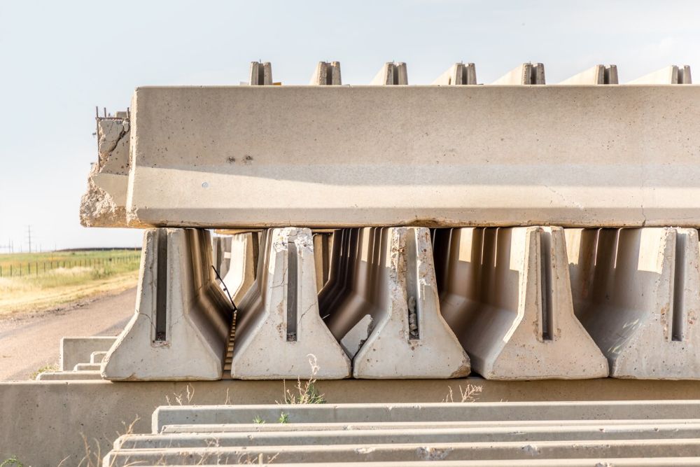 concrete-parts-piled-up-besides-rural-road-besides-highway_333098-16