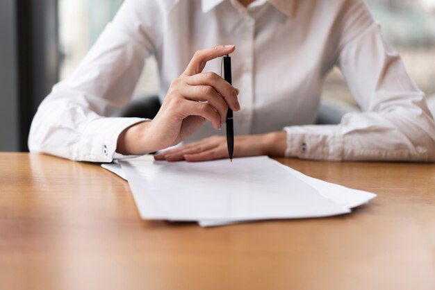 front-view-business-woman-clicking-pen_23-2148377791