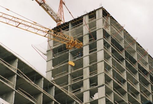 free-photo-of-crane-near-concrete-buidling-under-construction