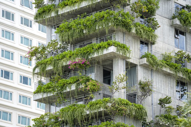 ecological-buildings-facade-with-green-plants-flowers-stone-wall-facade-house-street-danang-city-vietnam_185094-536