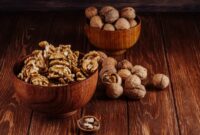 side-view-walnuts-wooden-bowl-dark-rustic-background_141793-7276
