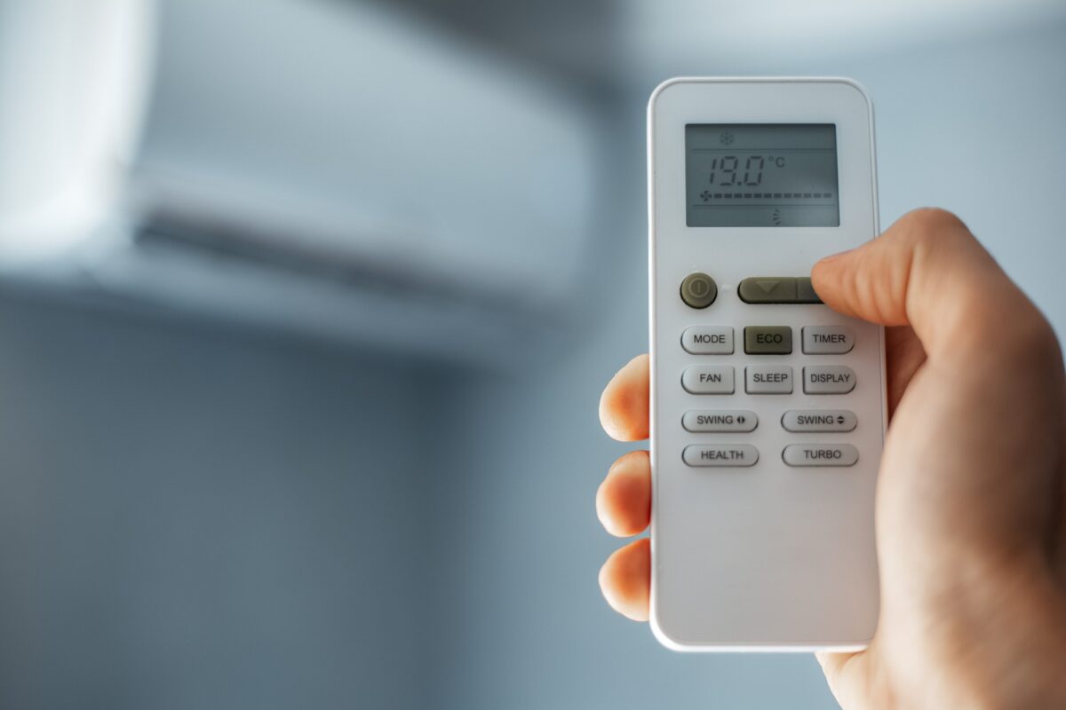 close-up-male-hand-holding-remote-control-air-conditioner_379201-2056-1
